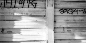 black dirt fence graffiti white