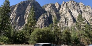 Mountain car parking road rock tree