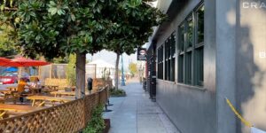 city walkway next to cafe seating