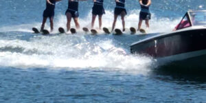 water skiing woman daytime ocean trees broll