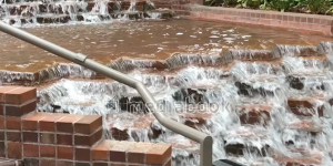 Fountain cascade daytime greenery handrail steps